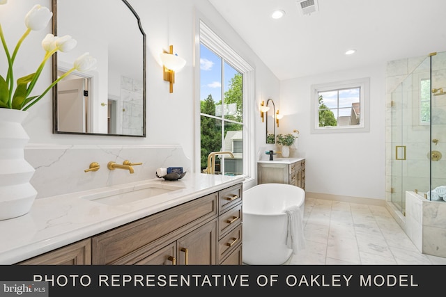 bathroom with independent shower and bath, vanity, and plenty of natural light