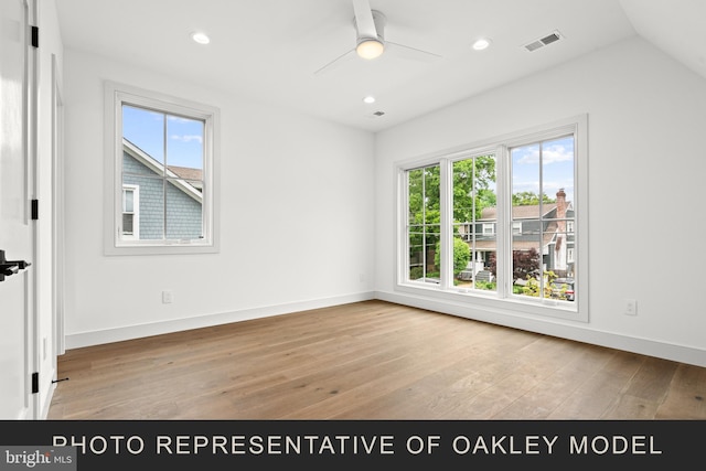 unfurnished room with ceiling fan, vaulted ceiling, plenty of natural light, and light hardwood / wood-style flooring