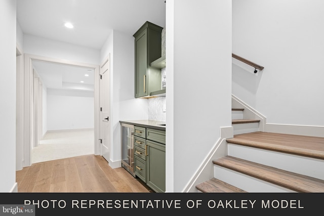 stairway featuring beverage cooler and hardwood / wood-style flooring