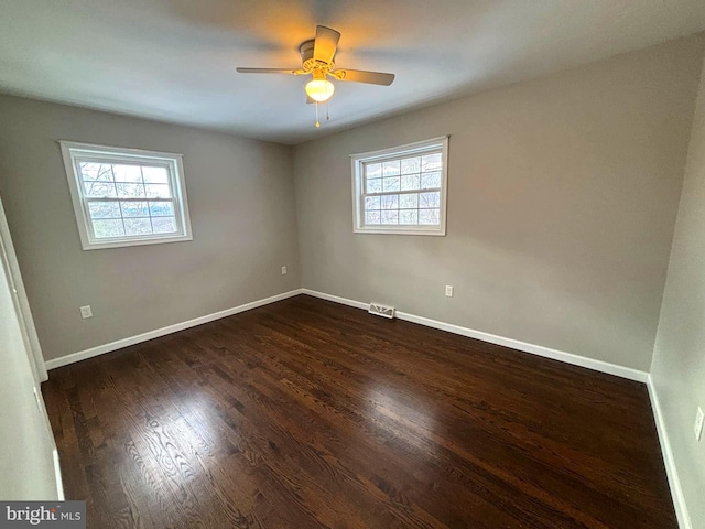 empty room featuring dark hardwood / wood-style floors and ceiling fan