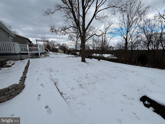 snowy yard with a wooden deck