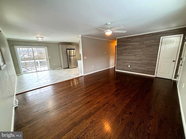 unfurnished living room with ceiling fan, wood-type flooring, and crown molding