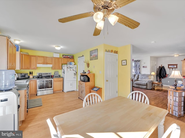 dining space with ceiling fan and light wood-type flooring