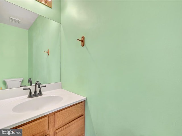 bathroom featuring toilet and vanity