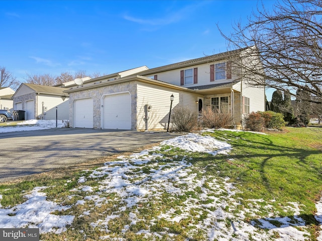 view of front property with a garage and a lawn