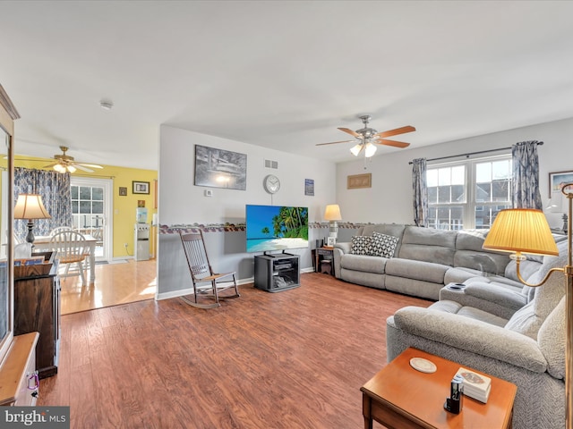 living room with ceiling fan and hardwood / wood-style flooring