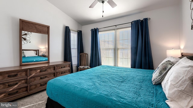 bedroom featuring ceiling fan, light colored carpet, and lofted ceiling