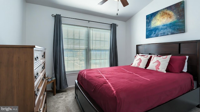 bedroom featuring light carpet, vaulted ceiling, and ceiling fan