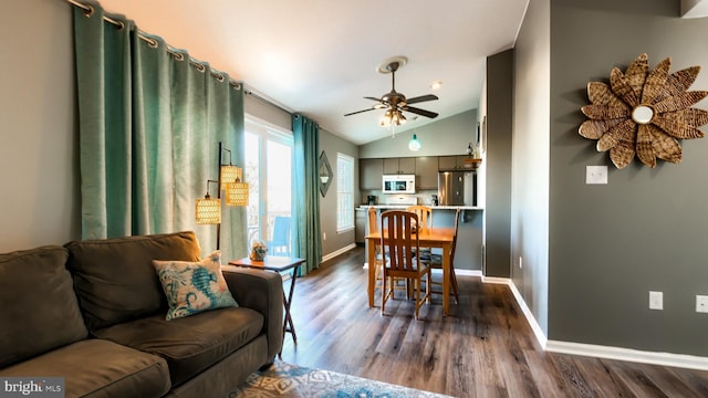 dining area with dark hardwood / wood-style flooring, ceiling fan, and lofted ceiling