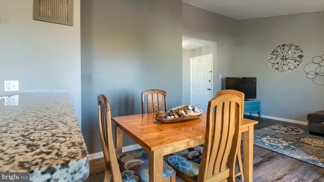 dining room with dark wood-type flooring