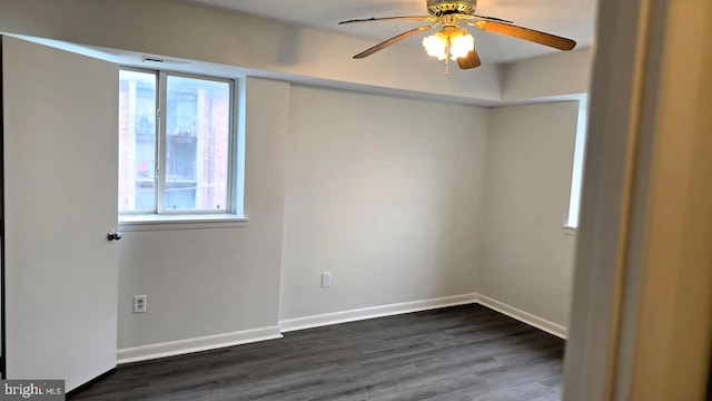 empty room with ceiling fan and dark wood-type flooring