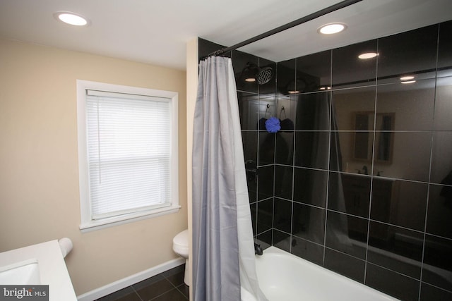 bathroom featuring shower / bath combo with shower curtain, tile patterned flooring, and toilet