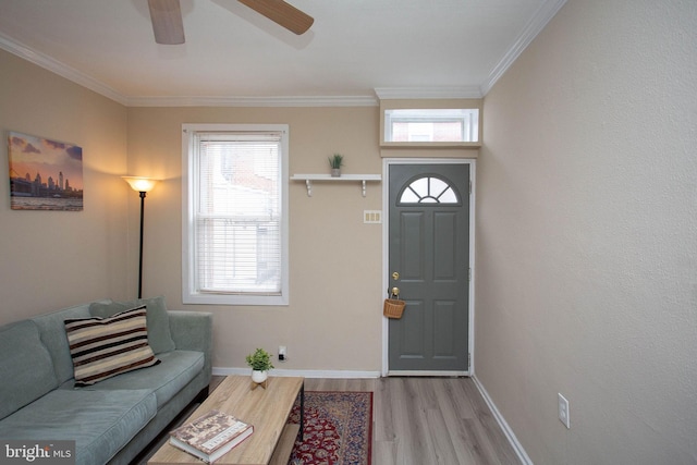 entrance foyer with hardwood / wood-style floors, ceiling fan, and crown molding