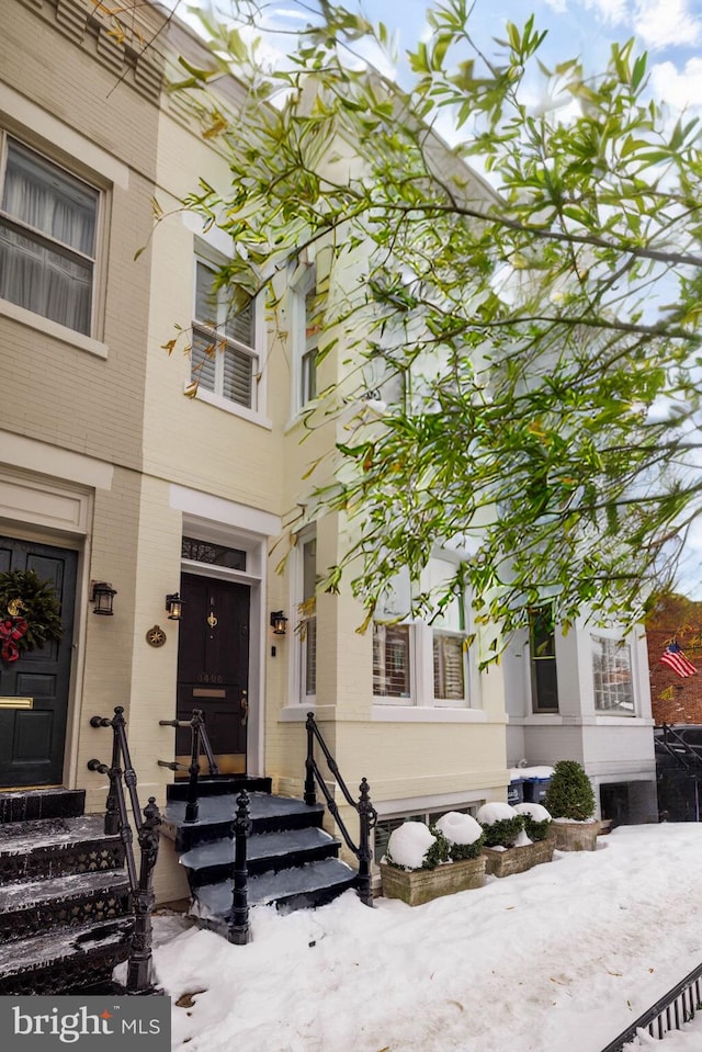 view of snow covered property entrance