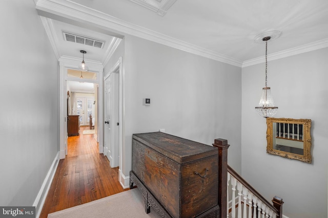 hallway featuring french doors, hardwood / wood-style flooring, and ornamental molding