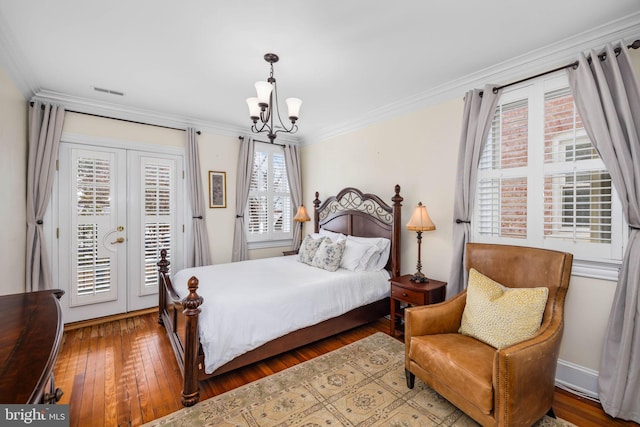 bedroom featuring french doors, hardwood / wood-style floors, a chandelier, access to outside, and ornamental molding