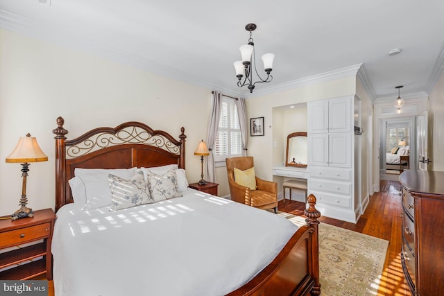 bedroom featuring a chandelier, dark hardwood / wood-style floors, and ornamental molding