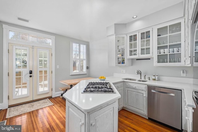 kitchen featuring kitchen peninsula, white cabinetry, french doors, and appliances with stainless steel finishes