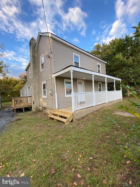 view of front of house with a front lawn and a porch