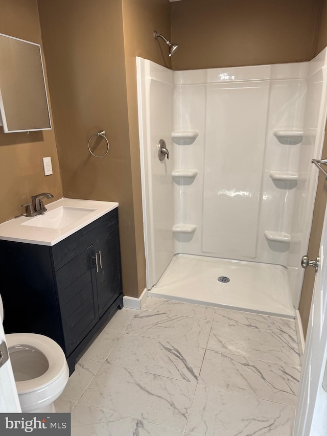 bathroom with walk in shower and vanity