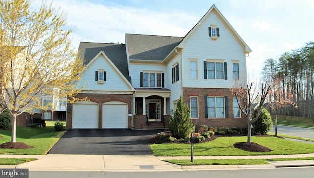 view of front of property with a garage and a front yard