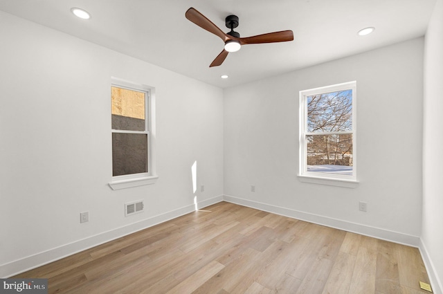 spare room with ceiling fan and light wood-type flooring