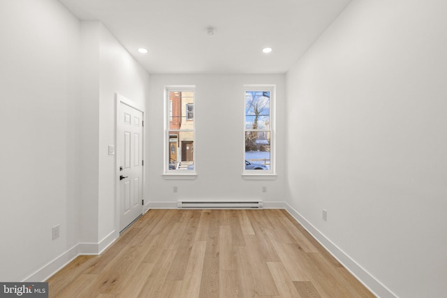 spare room featuring light hardwood / wood-style floors and a baseboard radiator