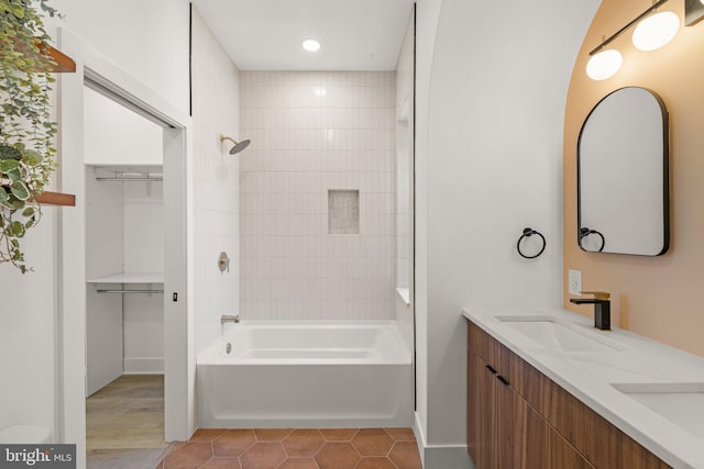 bathroom featuring tile patterned floors, vanity, and tiled shower / bath