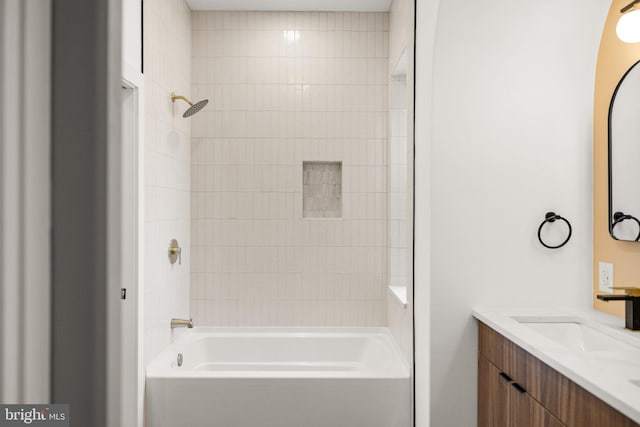 bathroom with vanity and tiled shower / bath