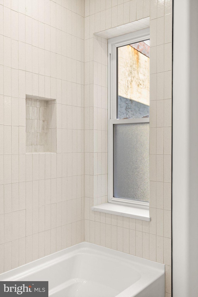 bathroom featuring a tub to relax in