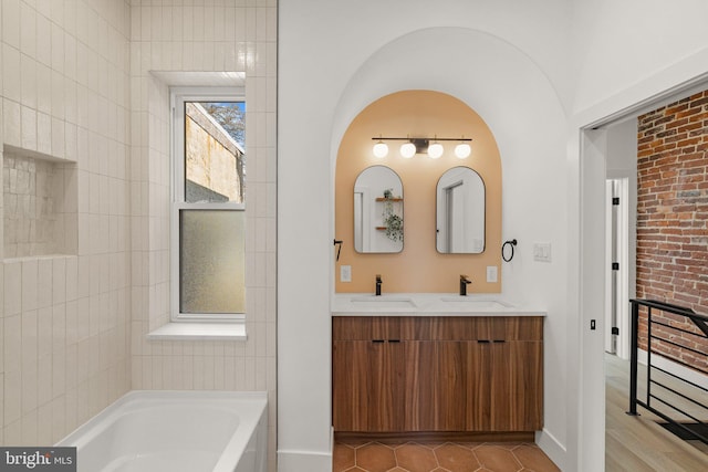 bathroom featuring tile patterned flooring, vanity, and a bathing tub