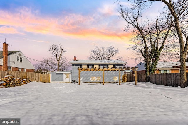 snowy yard with a pergola