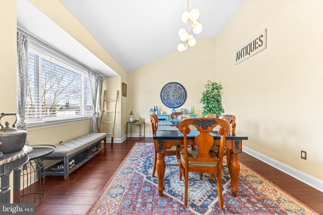 dining area with dark wood-type flooring, vaulted ceiling, and a notable chandelier