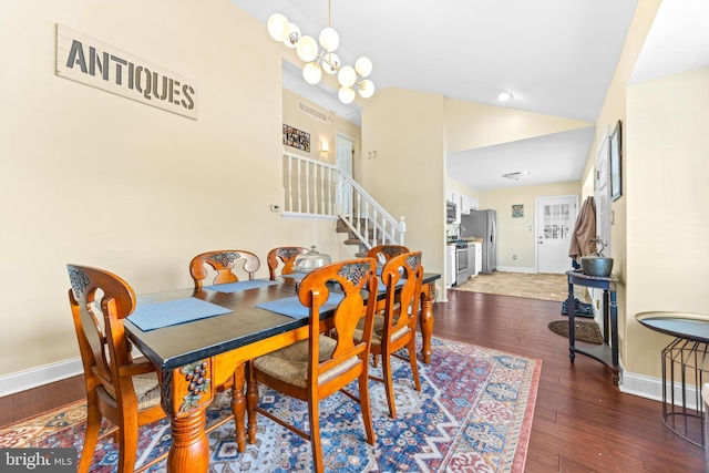 dining space with vaulted ceiling, dark hardwood / wood-style floors, and a notable chandelier