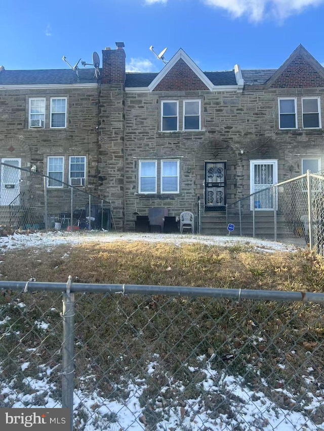 view of snow covered back of property