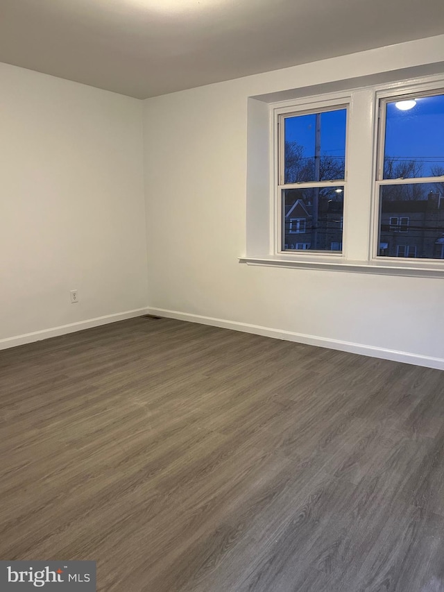 empty room featuring dark hardwood / wood-style floors