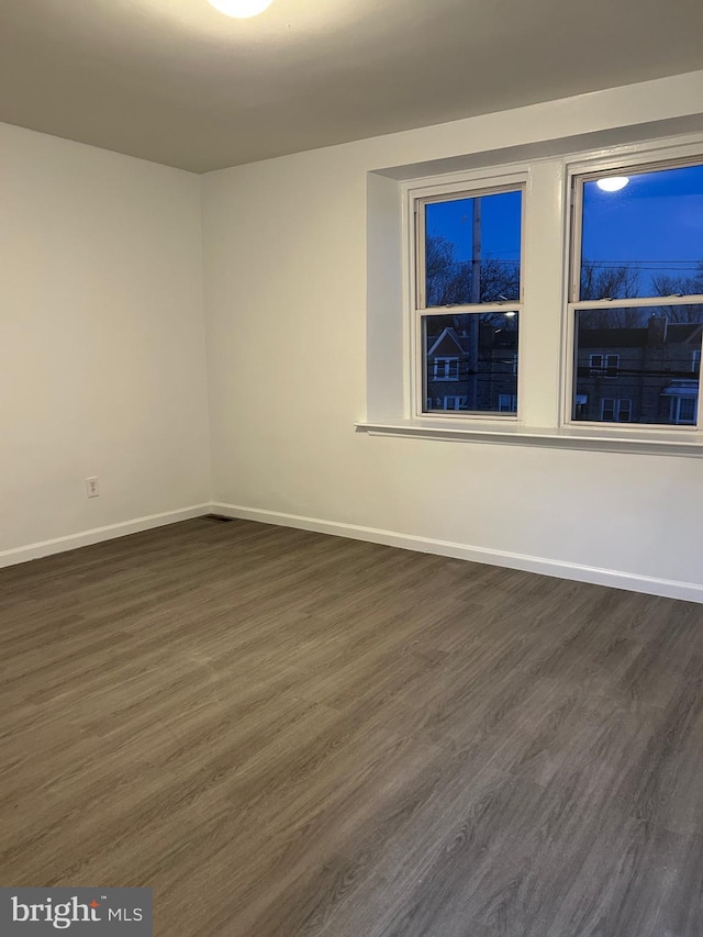 spare room featuring dark hardwood / wood-style flooring