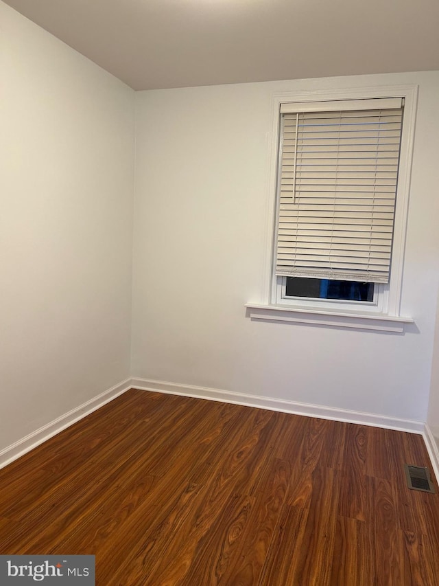 empty room featuring dark wood-type flooring