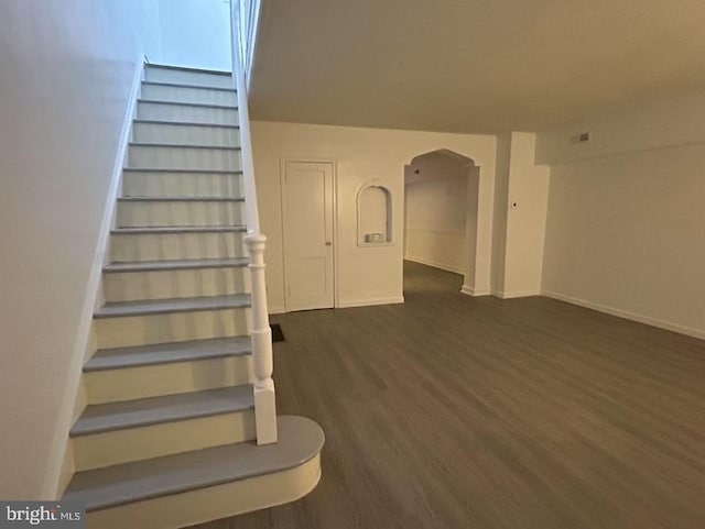 stairs featuring wood-type flooring