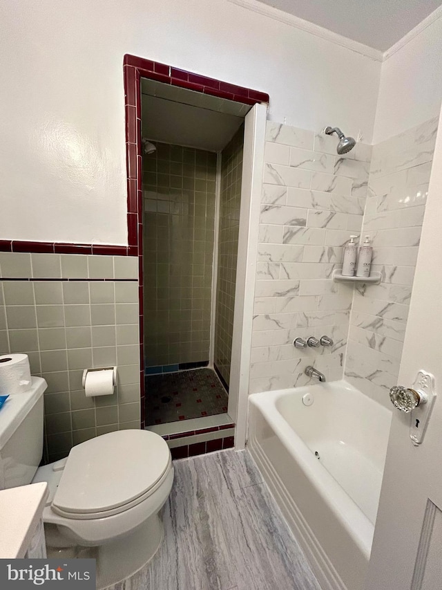 bathroom with wood-type flooring, tile walls, tiled shower / bath combo, toilet, and crown molding