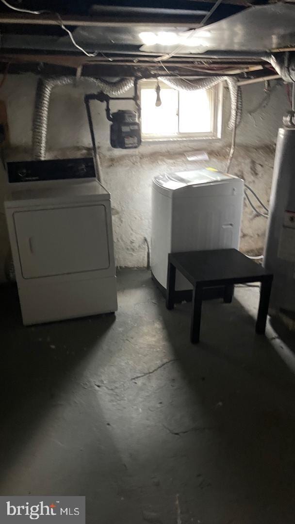 basement featuring independent washer and dryer and fridge