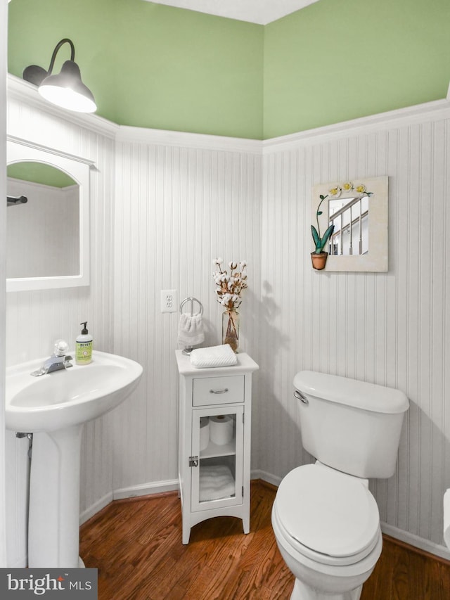 bathroom with sink, toilet, and hardwood / wood-style flooring