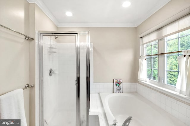 bathroom with plus walk in shower, ornamental molding, and a healthy amount of sunlight