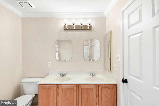 bathroom featuring vanity, toilet, and ornamental molding