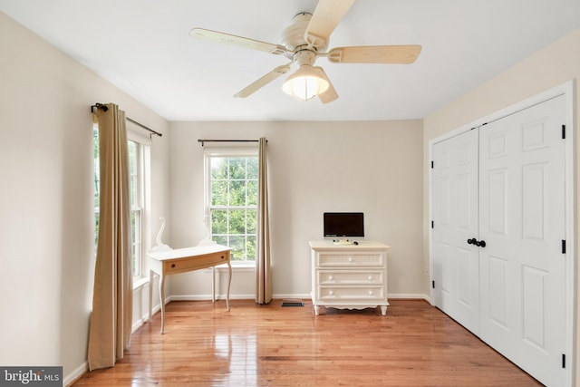 unfurnished bedroom with ceiling fan, a closet, and light hardwood / wood-style flooring