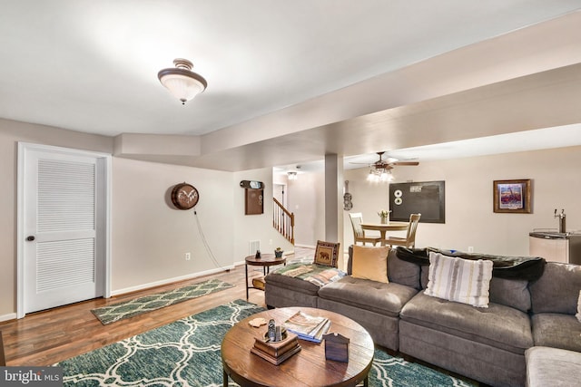 living room with wood-type flooring and ceiling fan