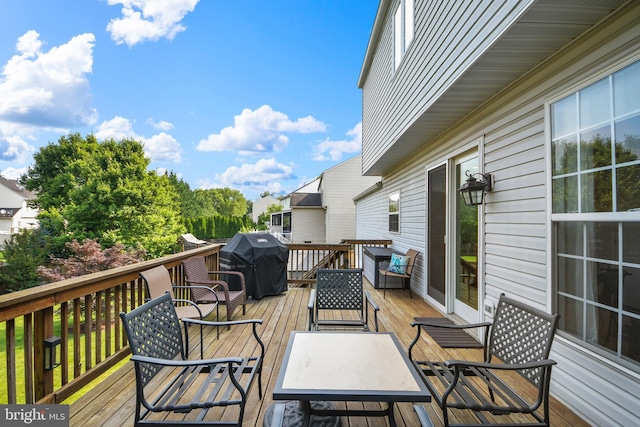 wooden deck featuring a grill