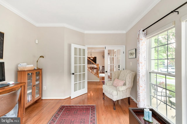 sitting room with french doors, light hardwood / wood-style floors, and ornamental molding