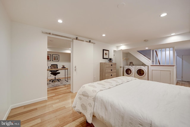 bedroom featuring light hardwood / wood-style floors and separate washer and dryer