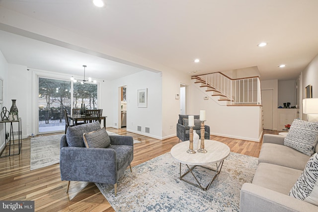 living room with hardwood / wood-style flooring and a chandelier